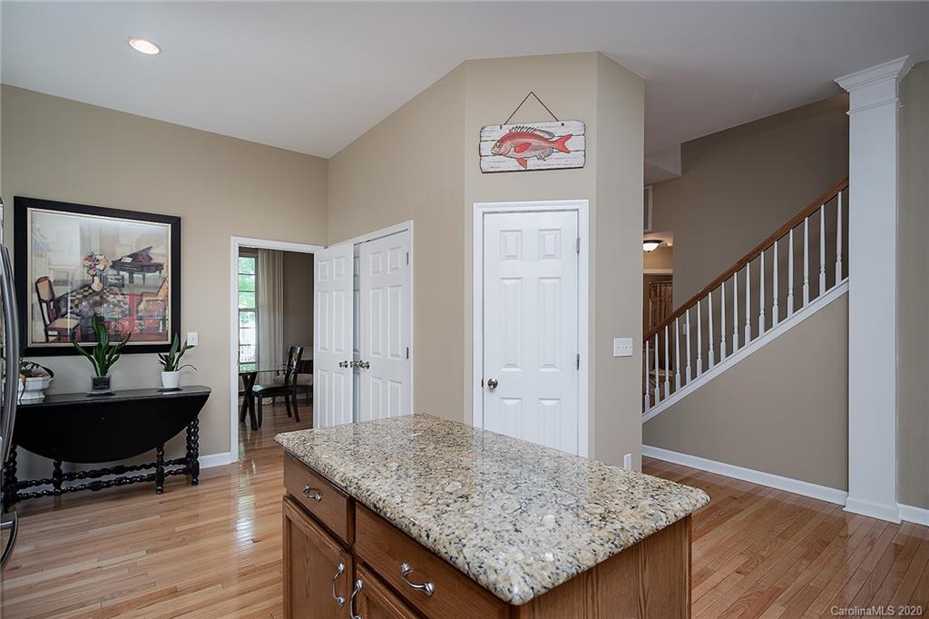 17214 Calverton Road Huntersville, NC 28078 - Photo 14 of 45 a view of a kitchen with kitchen island dining table and wooden floor