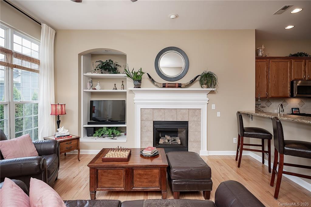 17214 Calverton Road Huntersville, NC 28078 - Photo 22 of 45 a living room with furniture a rug a fireplace and a window