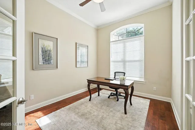 a view of a workspace with furniture and a window