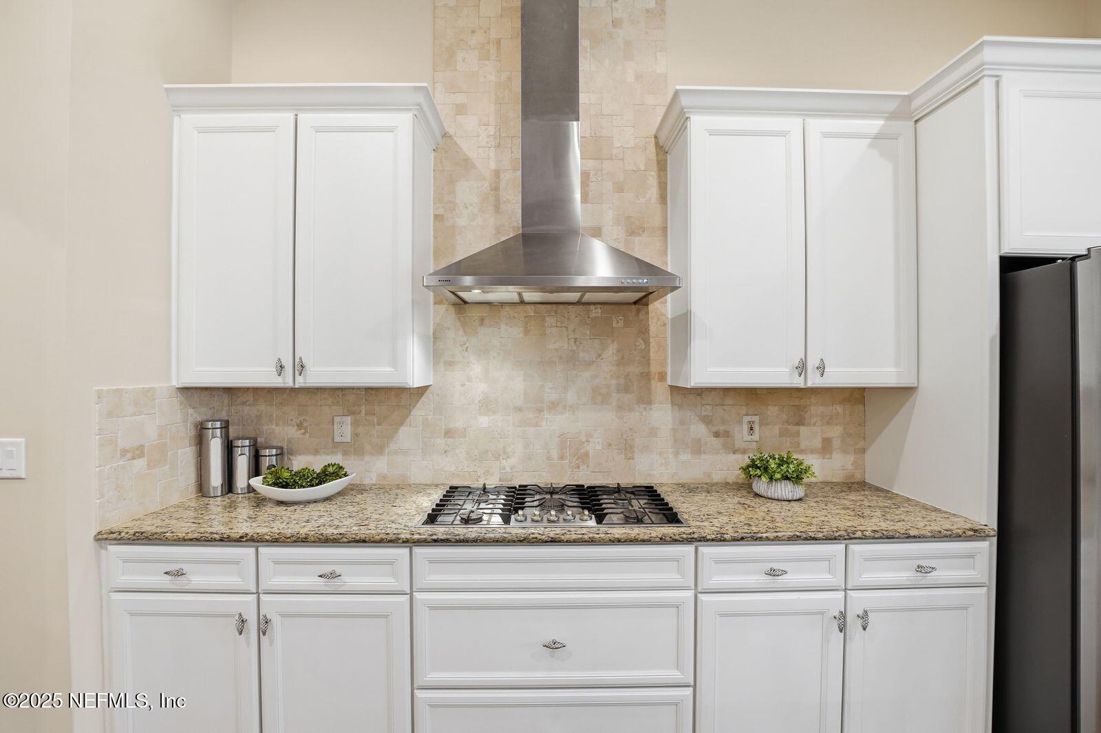 524 Sebastian Square St. Augustine, FL 32095 - Photo 14 of 32 a kitchen with granite countertop white cabinets and white appliances