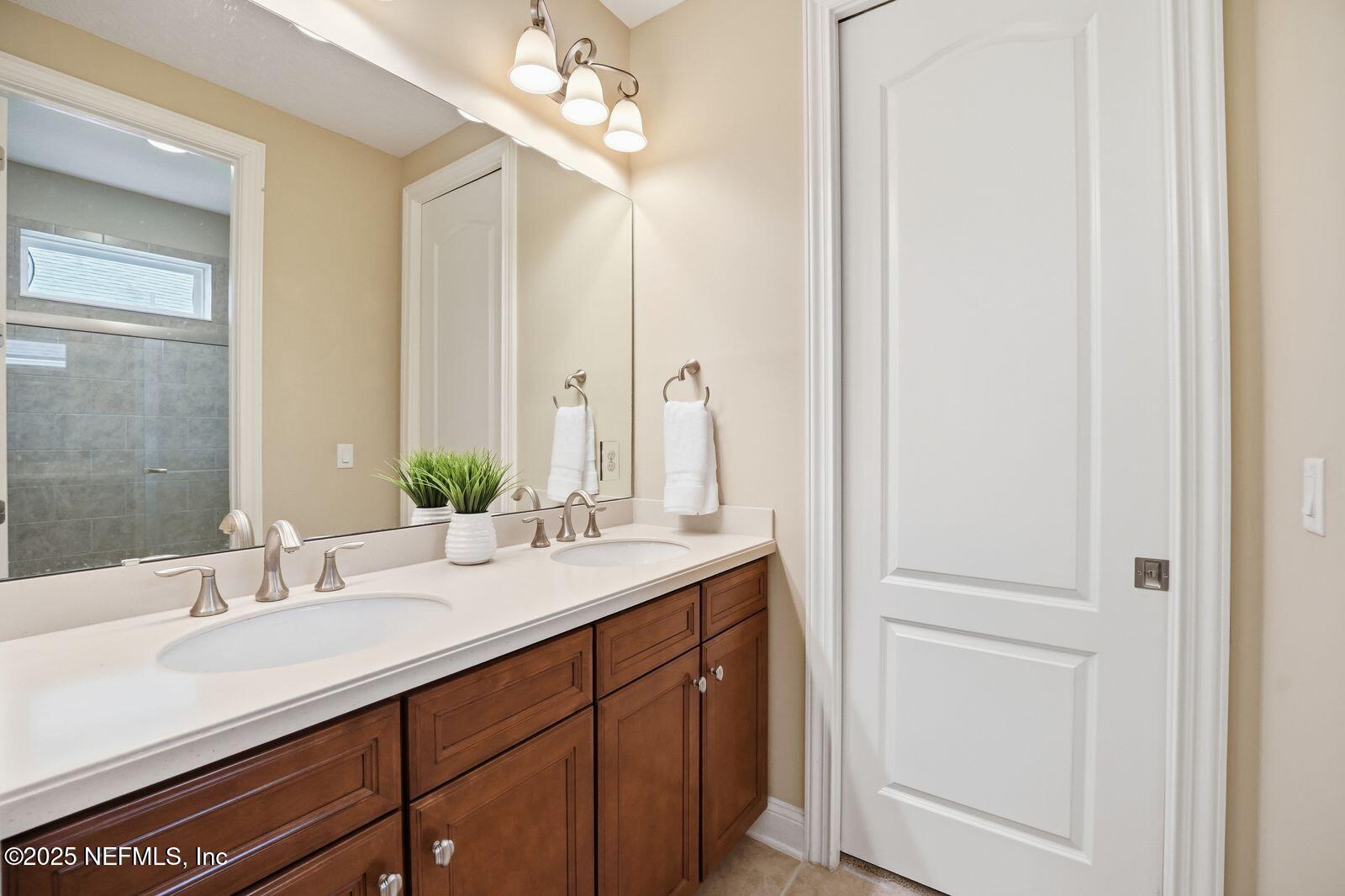 524 Sebastian Square St. Augustine, FL 32095 - Photo 20 of 32 a bathroom with a double vanity sink and a mirror