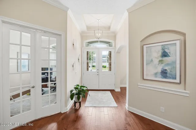 a view of an entryway with wooden floor