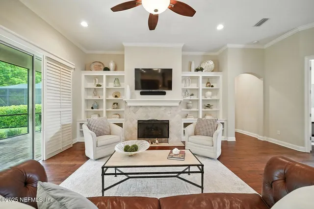 a living room with furniture a flat screen tv and a fireplace