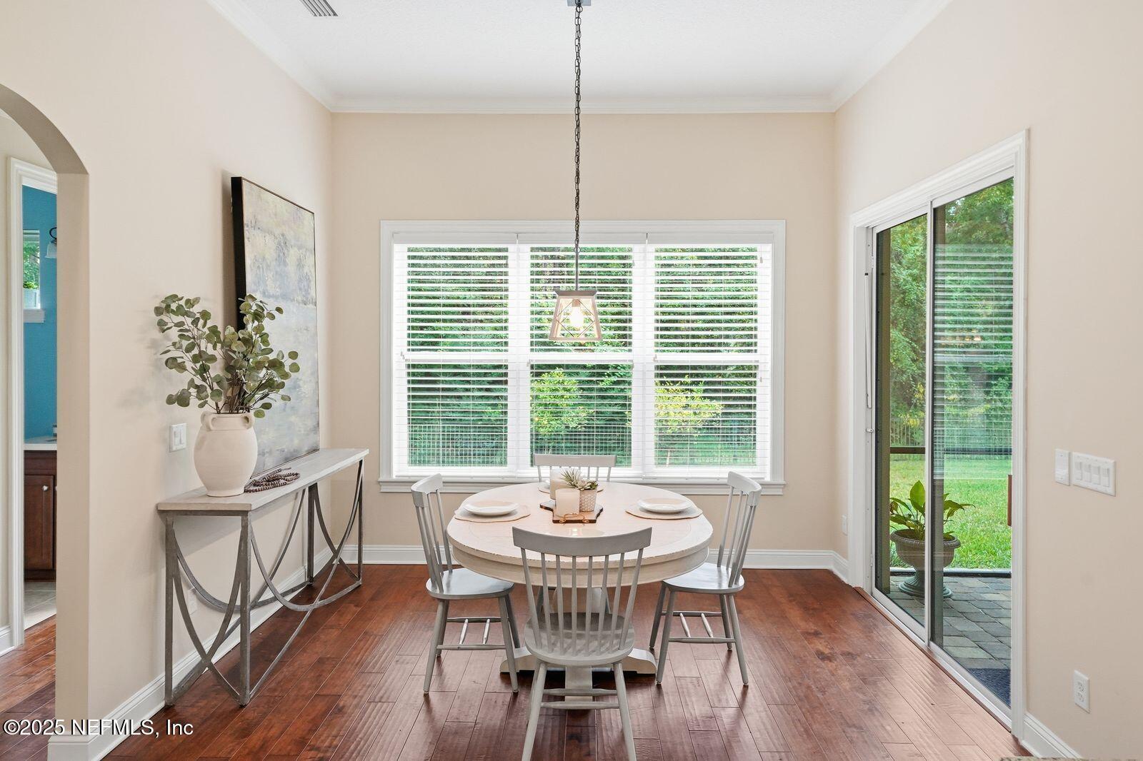 524 Sebastian Square St. Augustine, FL 32095 - Photo 5 of 32 a dining room with furniture a chandelier and wooden floor
