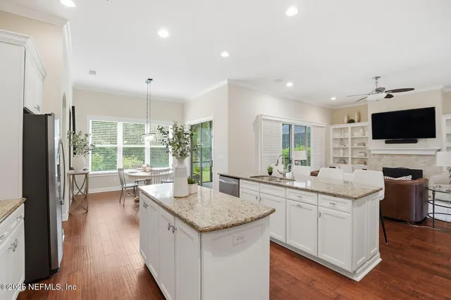 a kitchen with sink stove and refrigerator