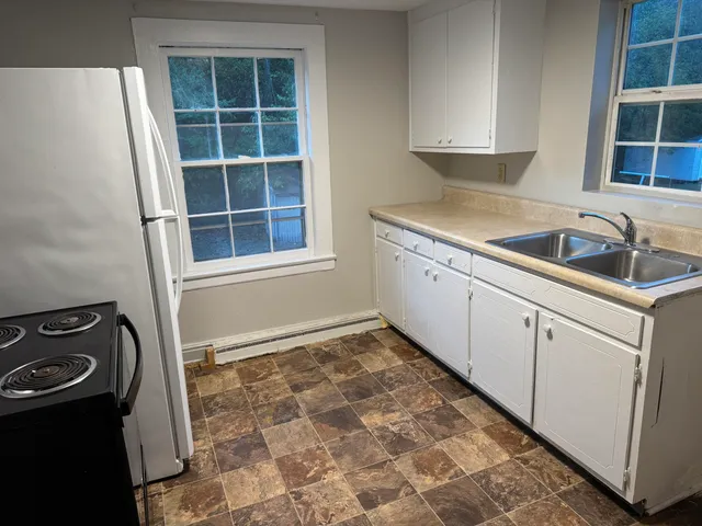 a kitchen with a sink stove and cabinets