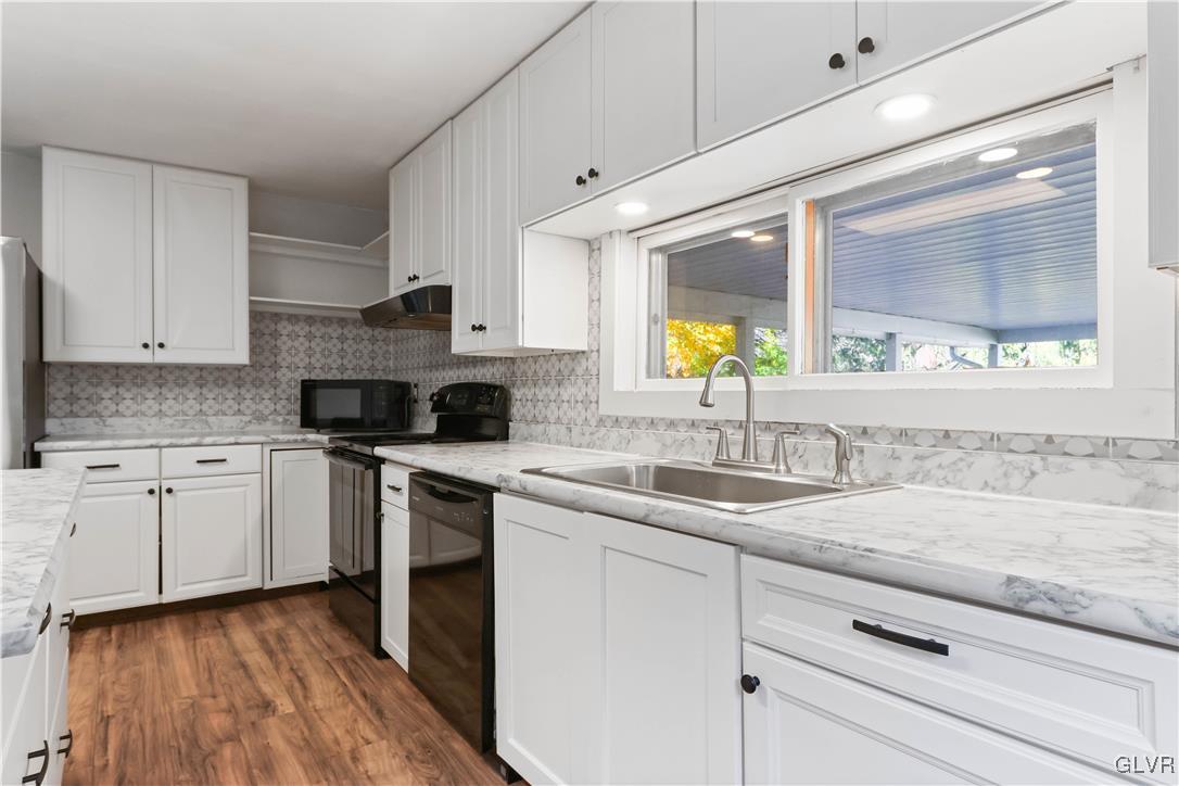 1802 Moselem Spring Road Hamburg, PA 19526 - Photo 14 of 50 a kitchen with a sink cabinets appliances and a window
