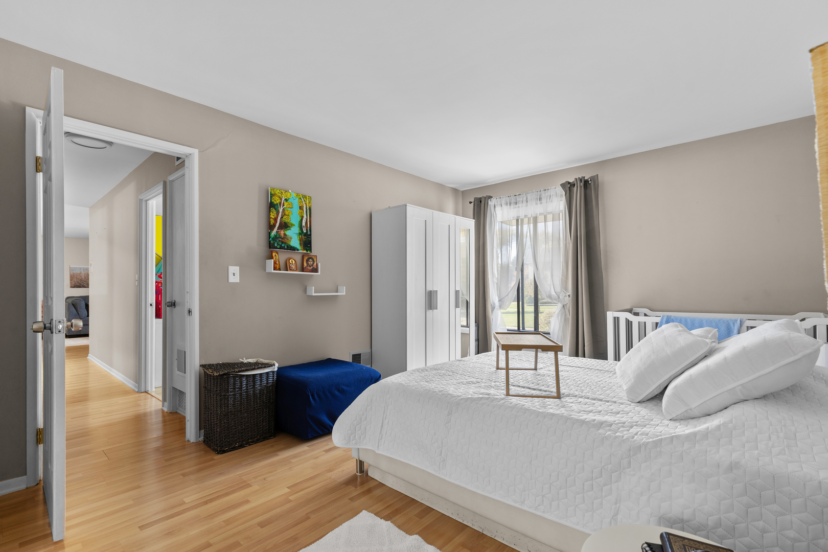 7353 Blackburn Avenue, Unit K206 Downers Grove, IL 60516 - Photo 16 of 24 a bedroom with a bed windows and wooden floor