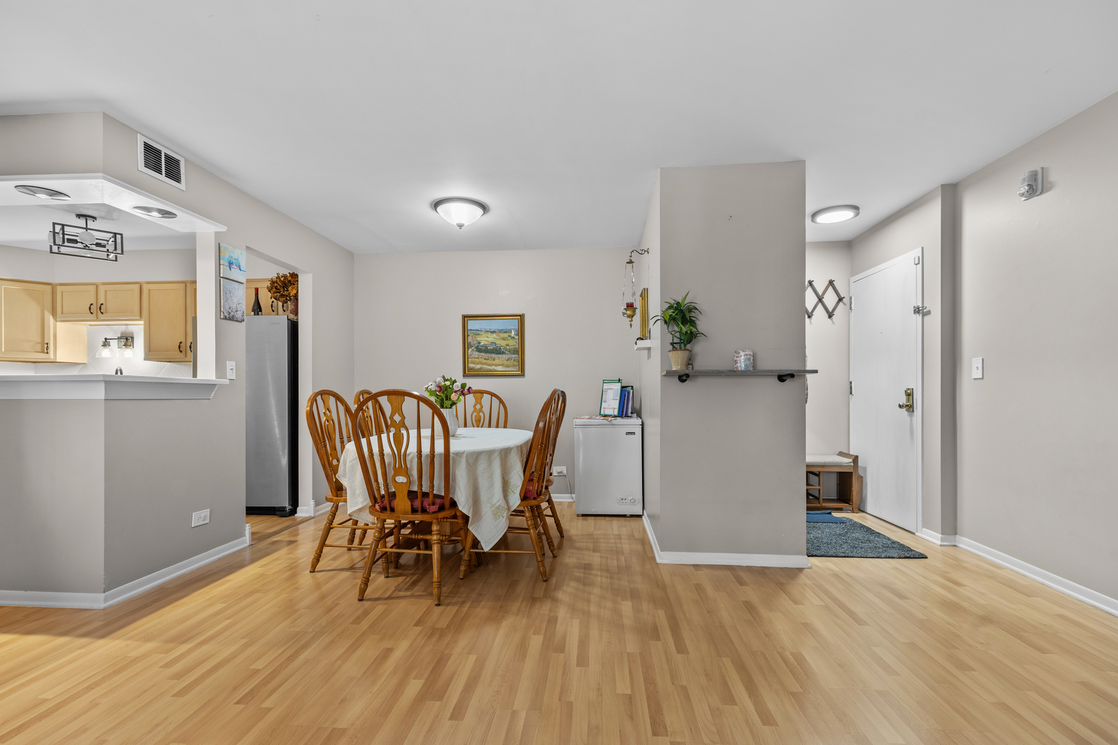 7353 Blackburn Avenue, Unit K206 Downers Grove, IL 60516 - Photo 5 of 24 a view of a dining room with furniture and wooden floor