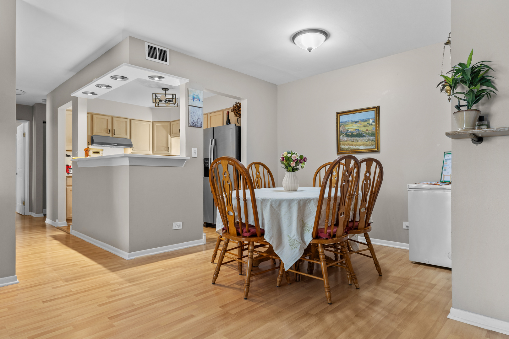 7353 Blackburn Avenue, Unit K206 Downers Grove, IL 60516 - Photo 6 of 24 a view of a dining room with furniture and wooden floor