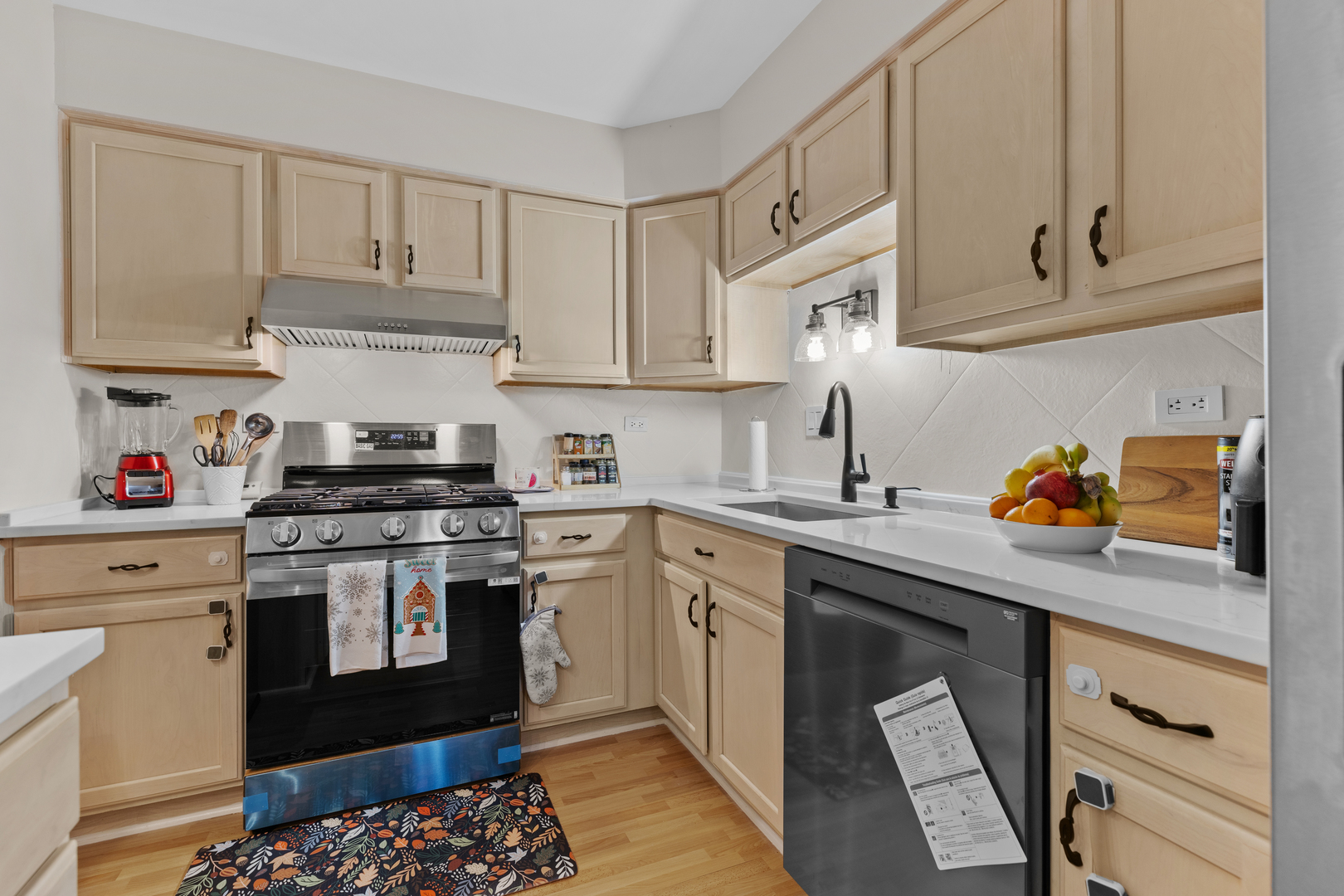 7353 Blackburn Avenue, Unit K206 Downers Grove, IL 60516 - Photo 7 of 24 a kitchen with stainless steel appliances granite countertop a sink stove and cabinets