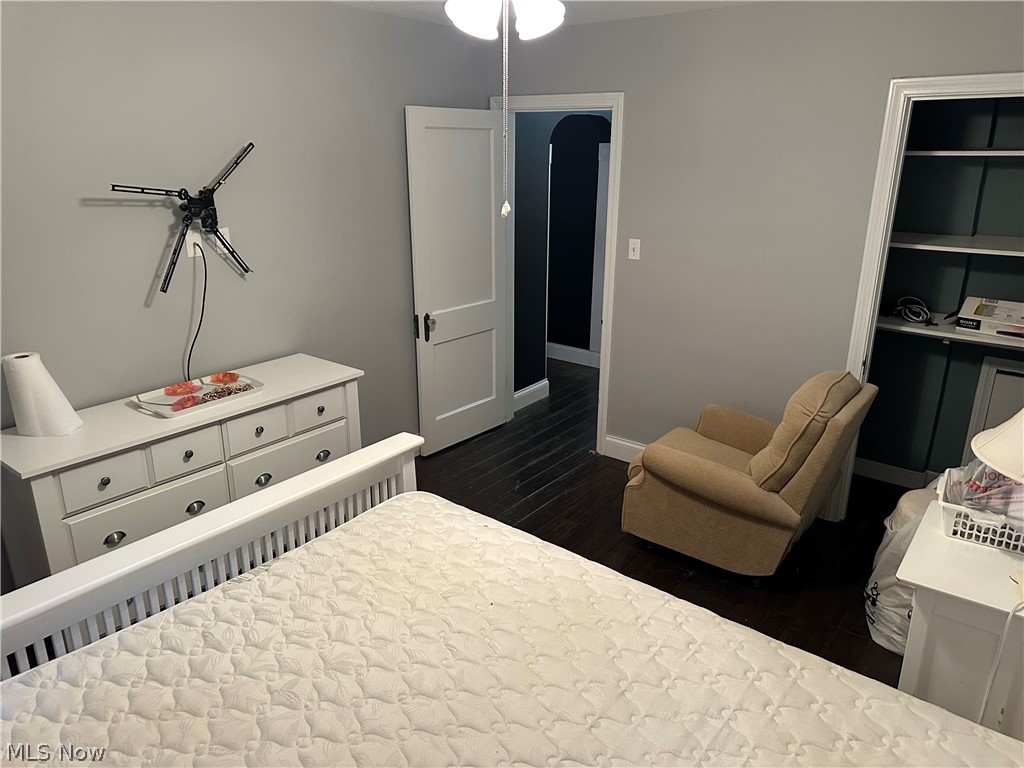 3192 Mogadore Road Akron, OH 44312 - Photo 20 of 43 First Floor Bedroom featuring dark wood-style floors and arched walkways