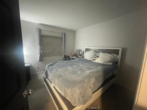 a bedroom with a bed and window