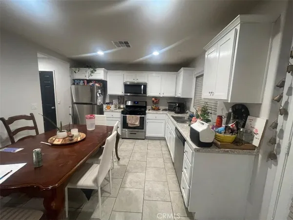 a kitchen with sink cabinets and appliances