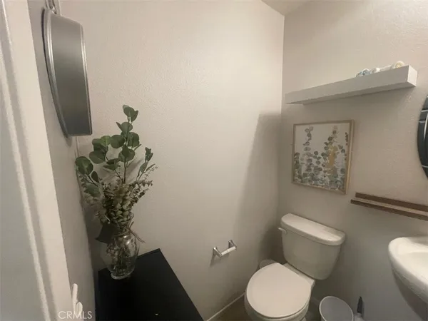 a bathroom with a toilet and a shower curtain