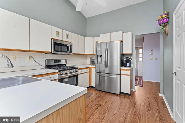 a kitchen with stainless steel appliances a refrigerator stove microwave and sink
