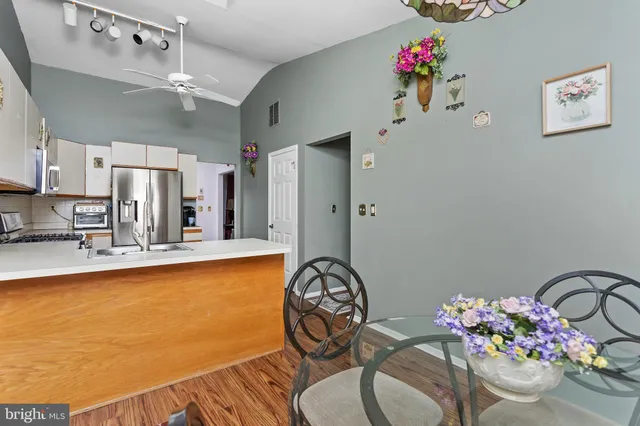 a view of a dining room with furniture and a chandelier