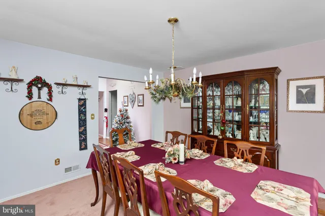 a view of a dining room with furniture and chandelier