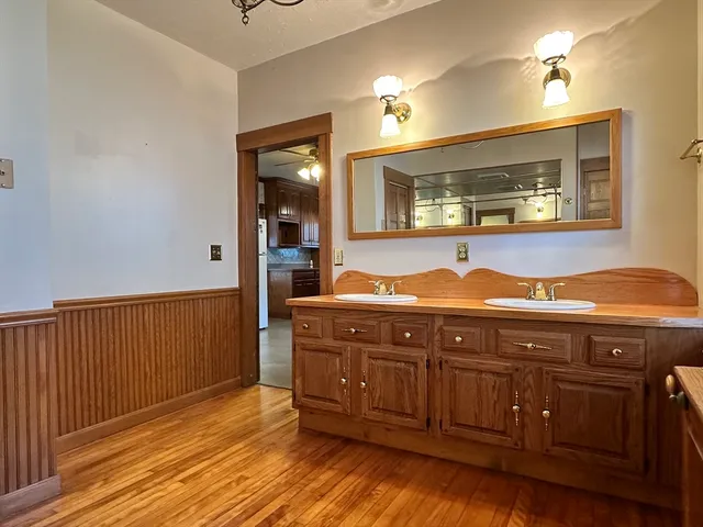 a spacious bathroom with a granite countertop toilet sink and mirror