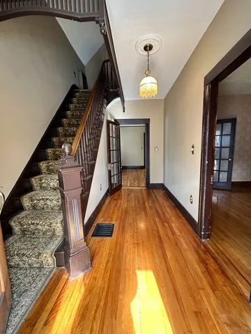 a view of an entryway with wooden floor