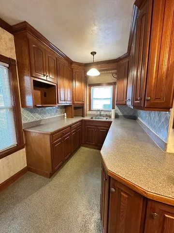 a kitchen with stainless steel appliances granite countertop a sink a stove counter space and cabinets