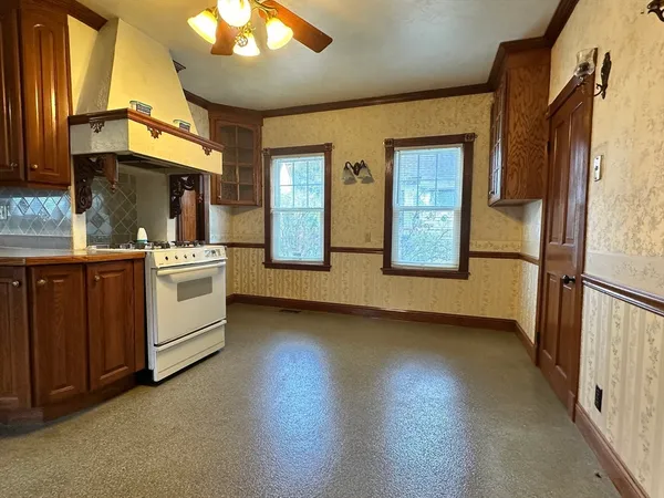 a view of a kitchen with a sink and dishwasher a refrigerator with wooden floor