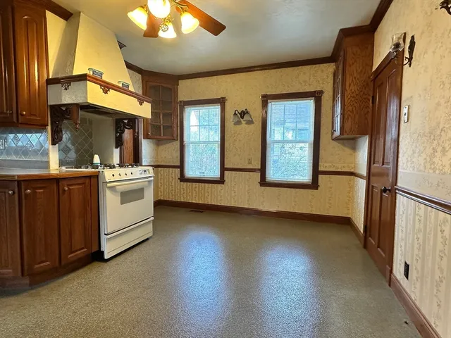 a view of a kitchen with a sink and dishwasher a refrigerator with wooden floor