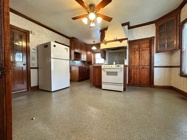 a kitchen with a refrigerator and a stove