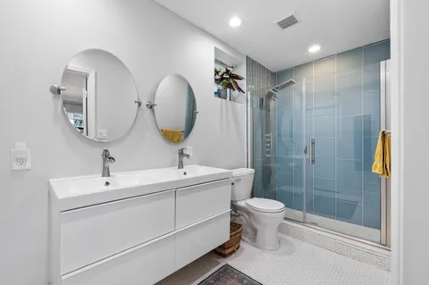 a bathroom with a toilet sink and mirror