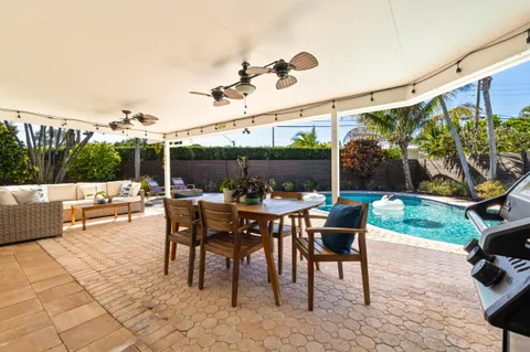 a outdoor space with lots of tables a garden and a couch