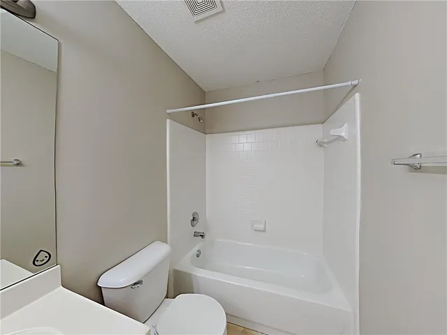 a bathroom with a toilet and a bath tub