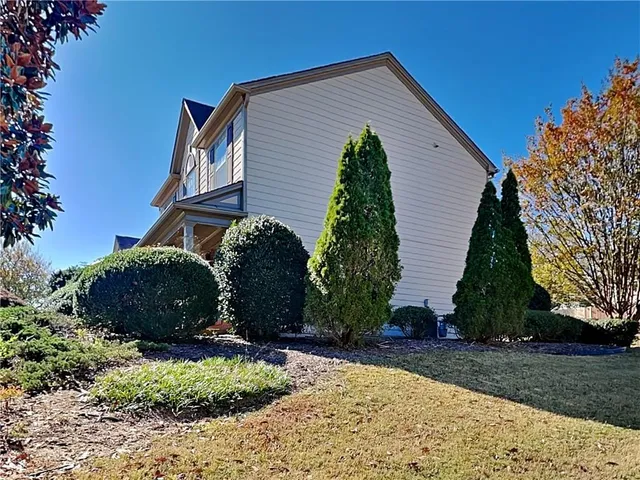a view of a house with a yard and plants