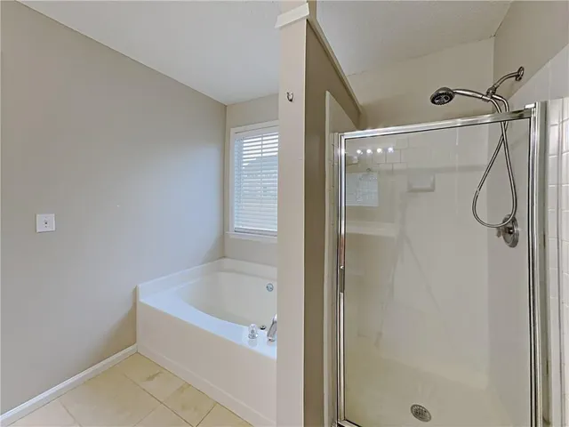 a bathroom with a bathtub and a shower
