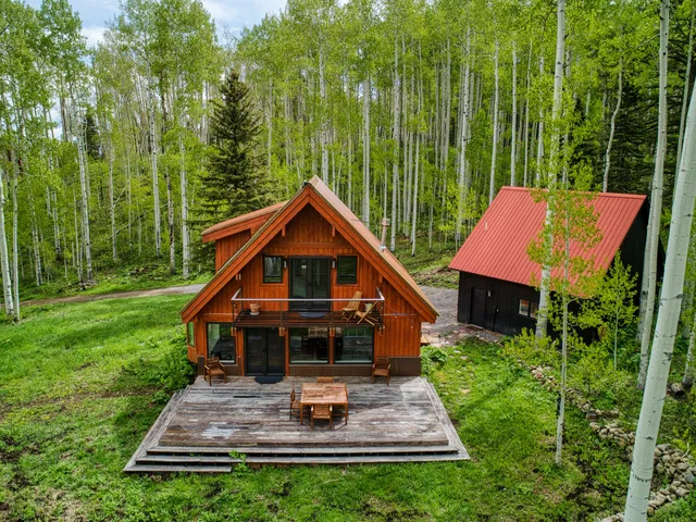 a front view of a house with a yard table and chairs