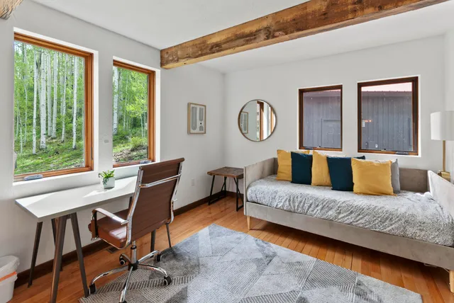 a living room with a bed furniture and a window