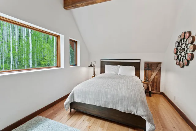 a bedroom with a bed and a large window