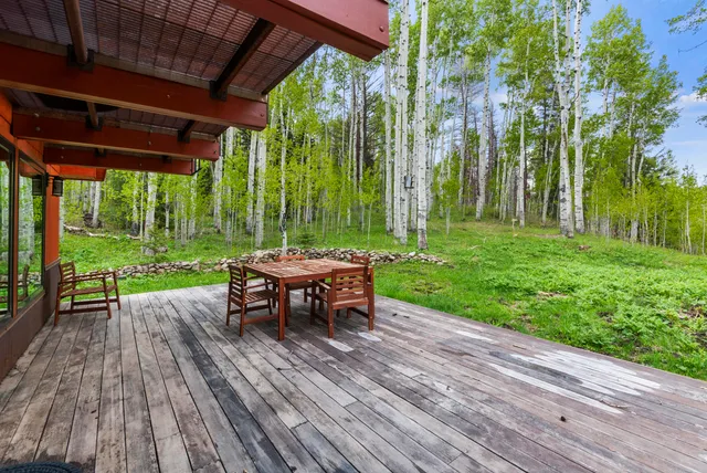 a view of a table and chairs in patio with wooden fence