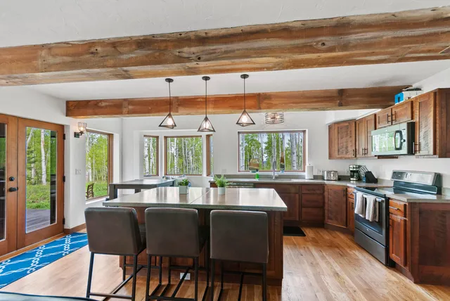 a open kitchen with stainless steel appliances granite countertop a stove and a refrigerator
