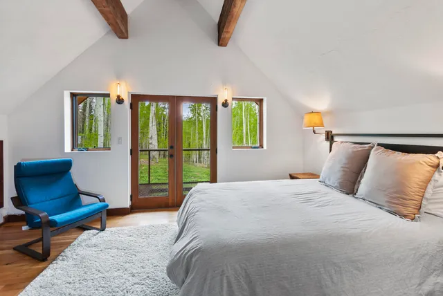 a bedroom with a bed a window and couch