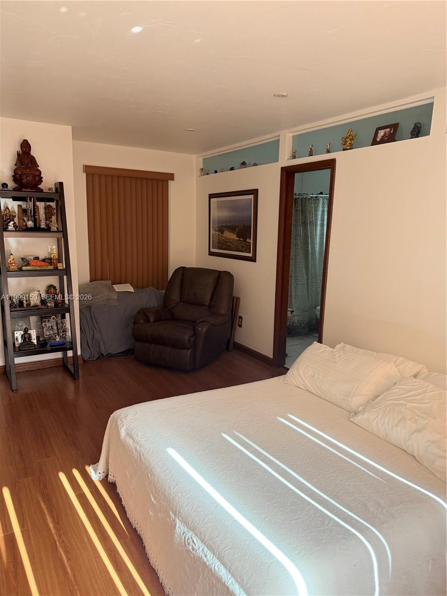 9410 Southwest 78th Street, Unit A Miami, FL 33173 - Photo 2 of 5 a bedroom with furniture and a window