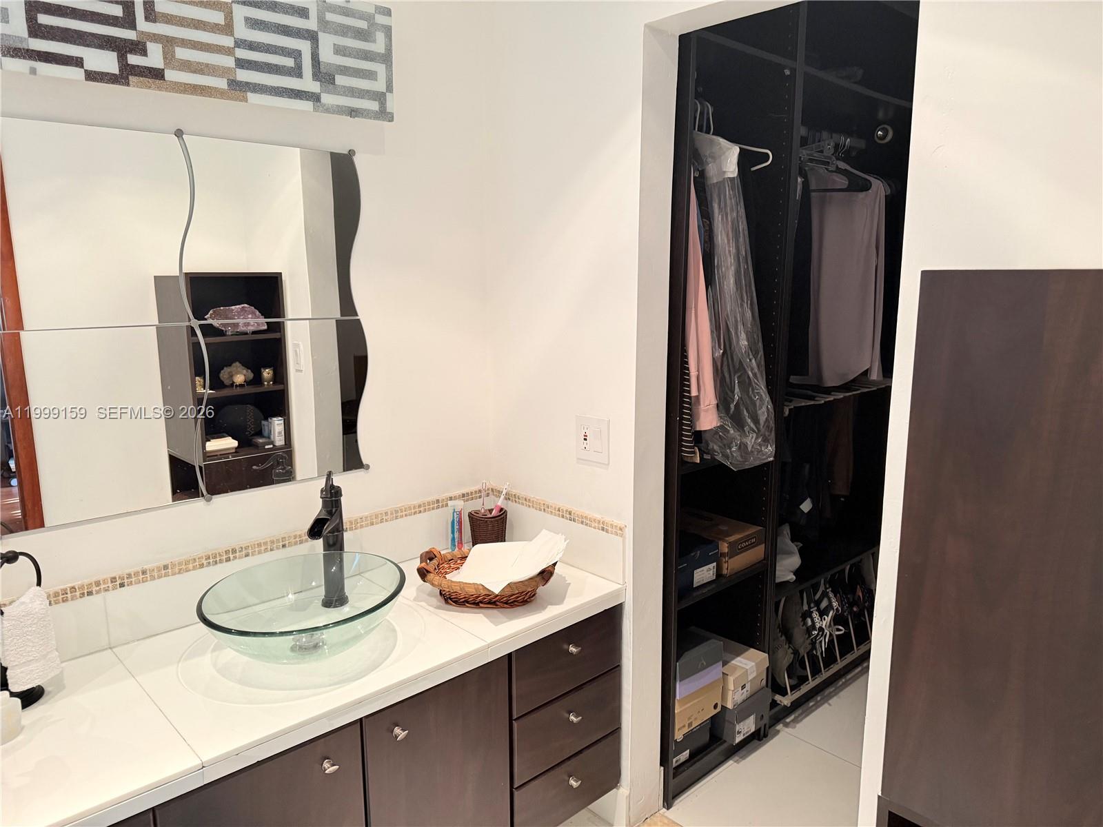 9410 Southwest 78th Street, Unit A Miami, FL 33173 - Photo 4 of 5 a bathroom with a sink and a mirror