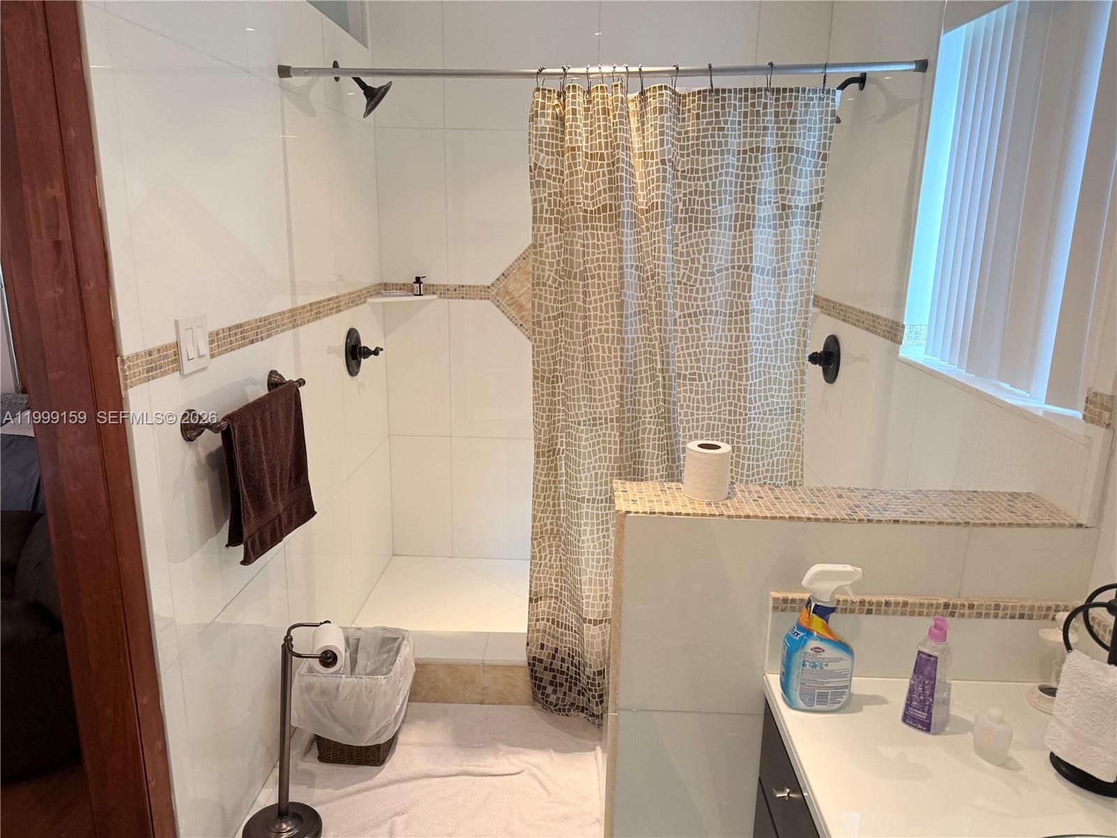 9410 Southwest 78th Street, Unit A Miami, FL 33173 - Photo 5 of 5 a bathroom with a sink and shower