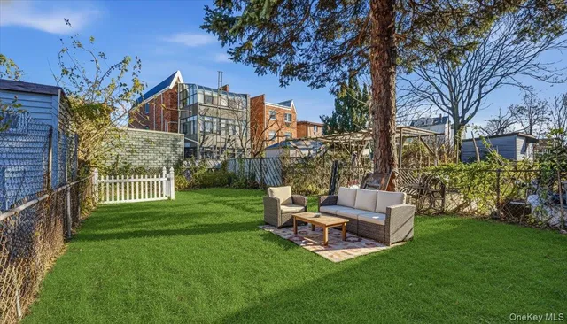 a view of a chair and table in the garden