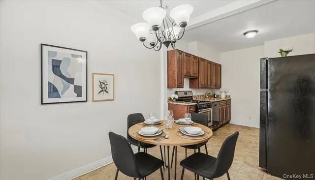 a view of a dining room with furniture and a chandelier
