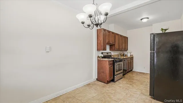 a kitchen with stainless steel appliances granite countertop a refrigerator a stove a sink dishwasher and a refrigerator with wooden floor