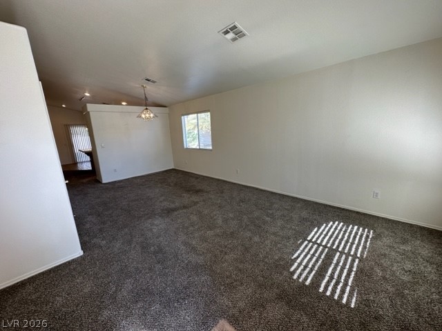 285 Spring Palms Street Henderson, NV 89012 - Photo 3 of 38 Living room featuring a notable chandelier, dark carpet, and visible vents