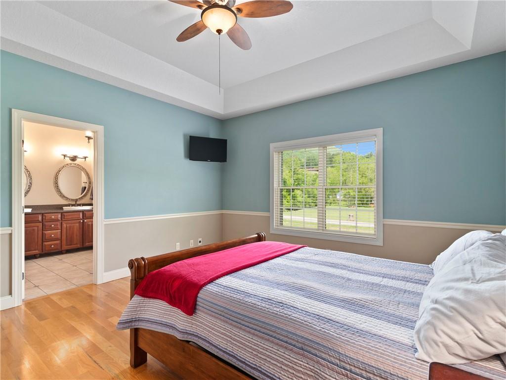 62 Vision Road Canton, NC 28716 - Photo 21 of 45 a bedroom with a large bed and a chandelier