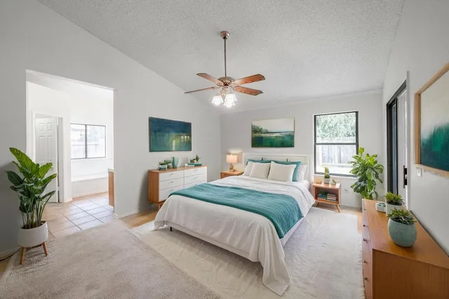 a bedroom with a large bed and a chandelier