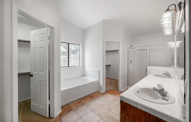 a bathroom with a tub sink and a mirror