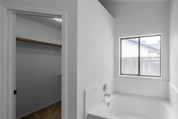 a white bath tub sitting next to a window